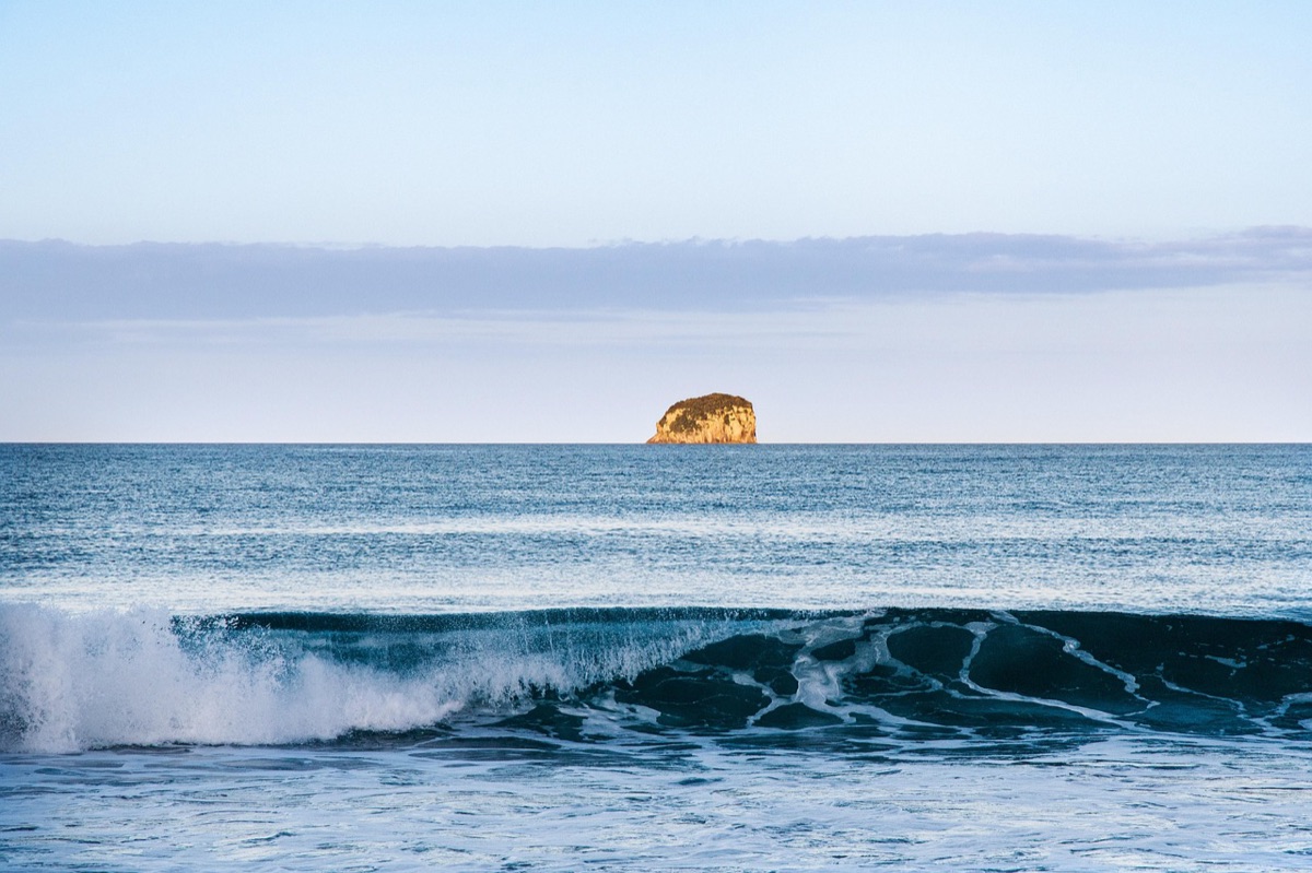 Distant island in clear blue sky