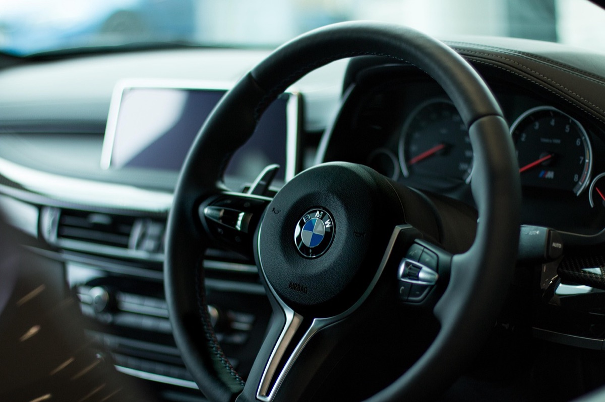 luxury rental car with tropical beach